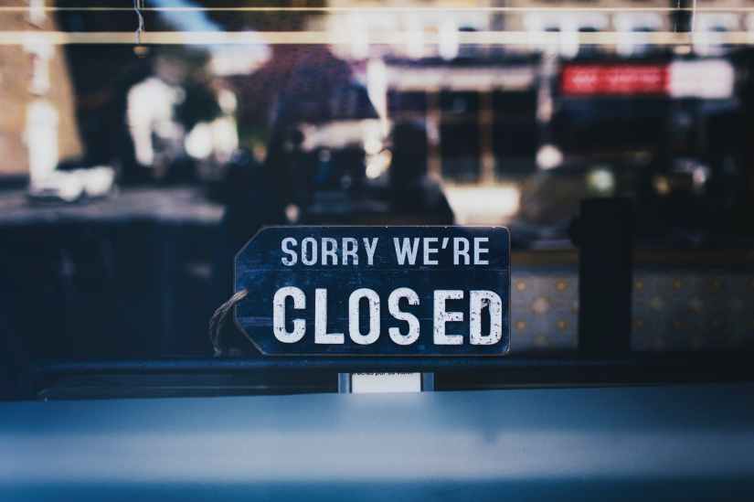 close up photo of sorry we re closed sign on glass window